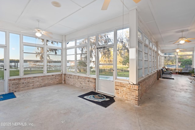 unfurnished sunroom featuring a ceiling fan