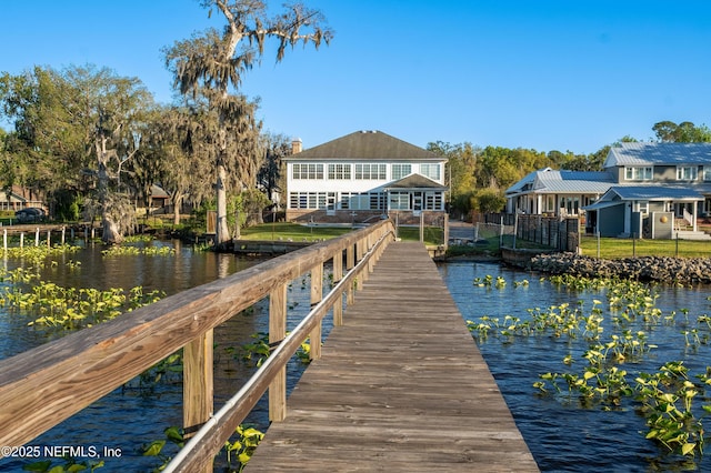 dock area featuring a water view and fence