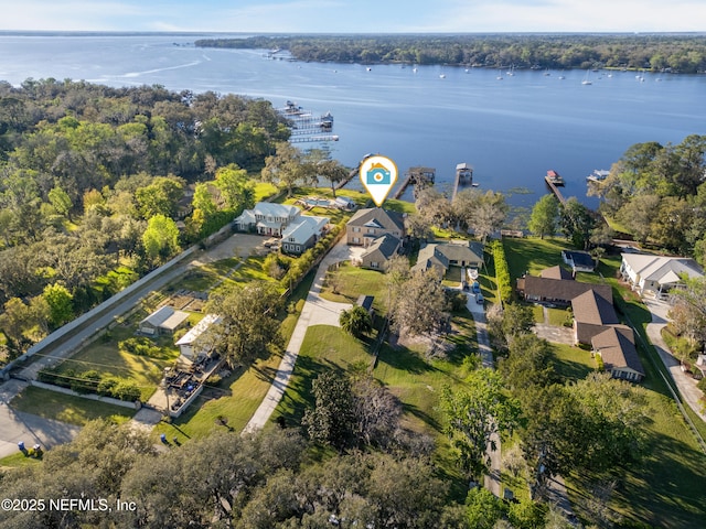 aerial view with a residential view, a wooded view, and a water view