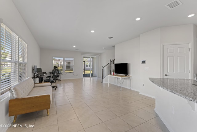 living room featuring light tile patterned floors, visible vents, recessed lighting, and baseboards