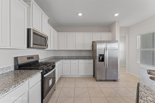 kitchen with white cabinets, light tile patterned floors, recessed lighting, and appliances with stainless steel finishes