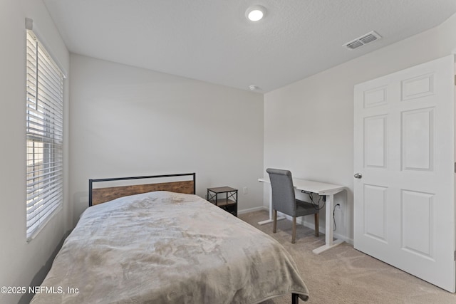 bedroom featuring visible vents, carpet floors, and baseboards