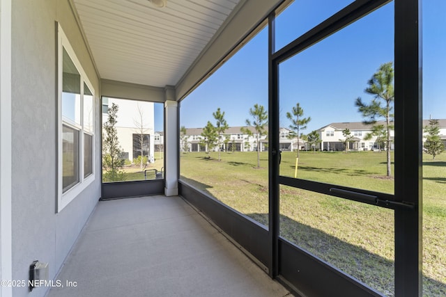 unfurnished sunroom featuring a residential view