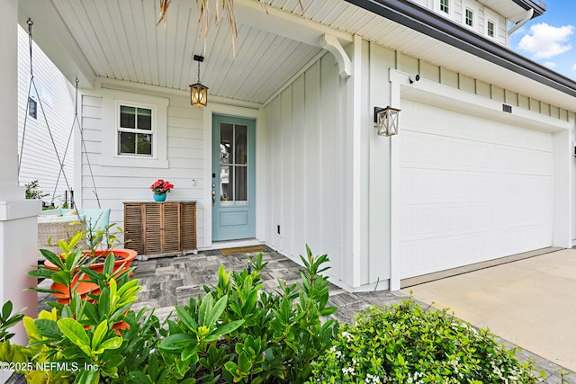 doorway to property featuring central air condition unit, board and batten siding, and concrete driveway