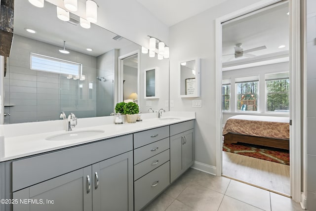 full bathroom featuring plenty of natural light, a tile shower, and a sink