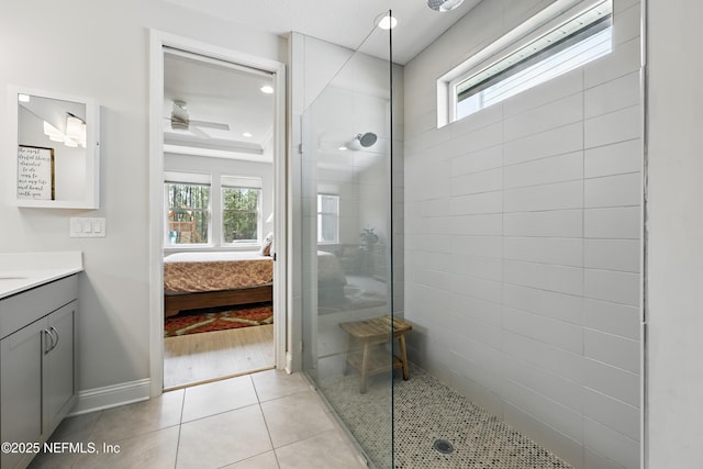 full bath with a walk in shower, ensuite bath, tile patterned flooring, baseboards, and vanity