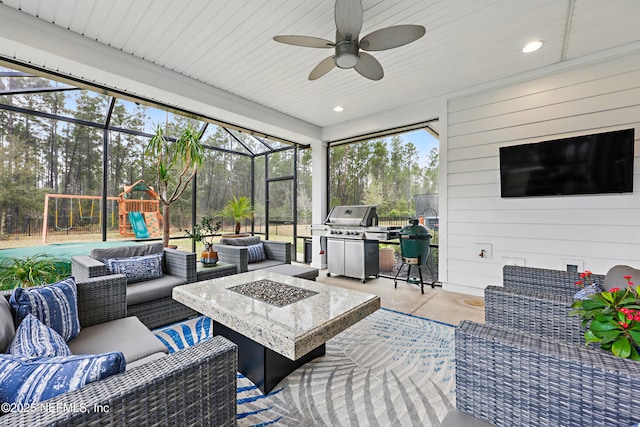 sunroom featuring a ceiling fan