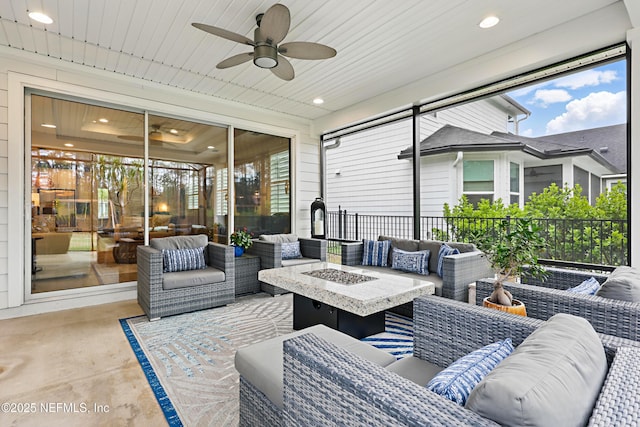 view of patio / terrace with an outdoor living space with a fire pit and ceiling fan