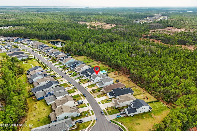 aerial view featuring a residential view and a view of trees