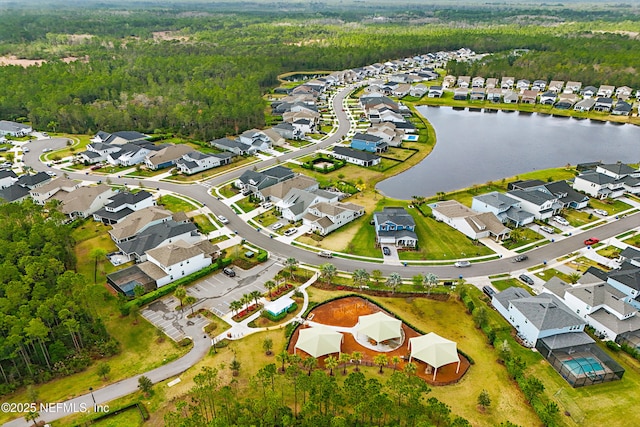 drone / aerial view featuring a residential view and a water view