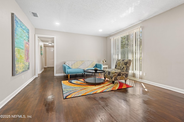 sitting room with visible vents, a textured ceiling, wood finished floors, recessed lighting, and baseboards