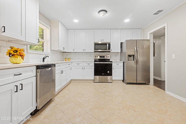 kitchen featuring white cabinetry, light countertops, visible vents, and stainless steel appliances