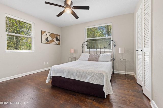 bedroom featuring a ceiling fan, baseboards, and wood finished floors