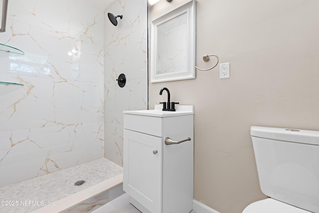 bathroom featuring a stall shower, toilet, and vanity