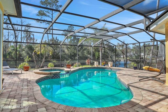 view of swimming pool with a lanai, a pool with connected hot tub, and a patio