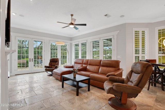 living room with stone tile flooring, visible vents, a healthy amount of sunlight, and french doors