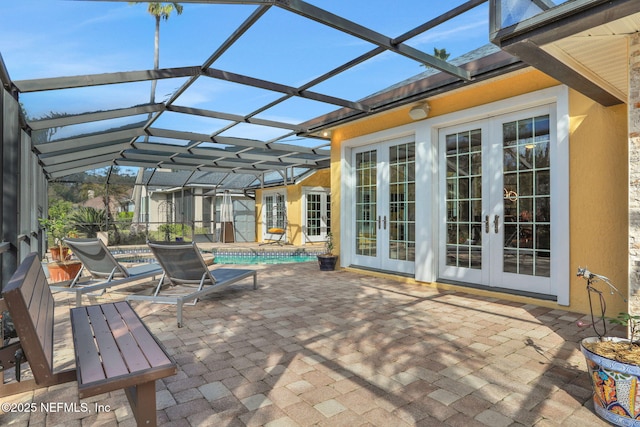 view of patio / terrace featuring an outdoor pool, french doors, and a lanai