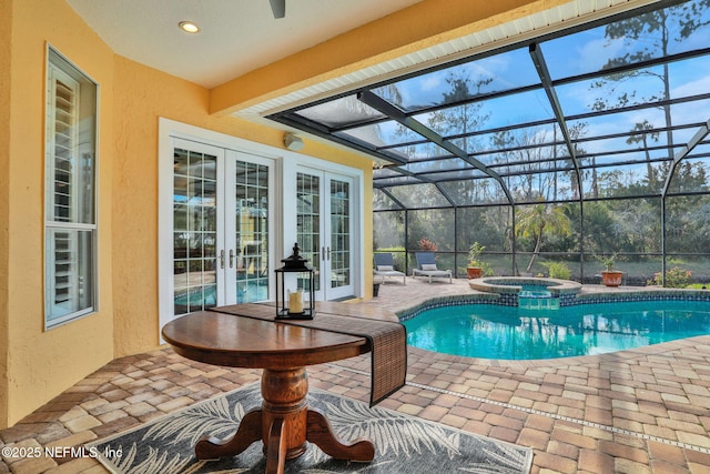 view of swimming pool featuring a patio area, glass enclosure, french doors, and a pool with connected hot tub