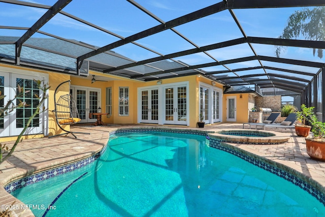 view of pool featuring a patio, a ceiling fan, a pool with connected hot tub, french doors, and a lanai