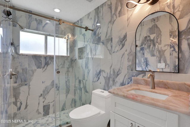 full bathroom featuring toilet, recessed lighting, a marble finish shower, tile walls, and vanity