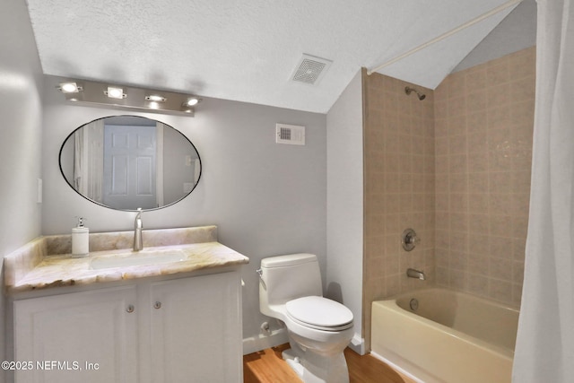 full bath with shower / bath combination with curtain, toilet, visible vents, and a textured ceiling