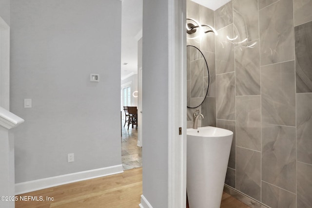 bathroom featuring baseboards and wood finished floors