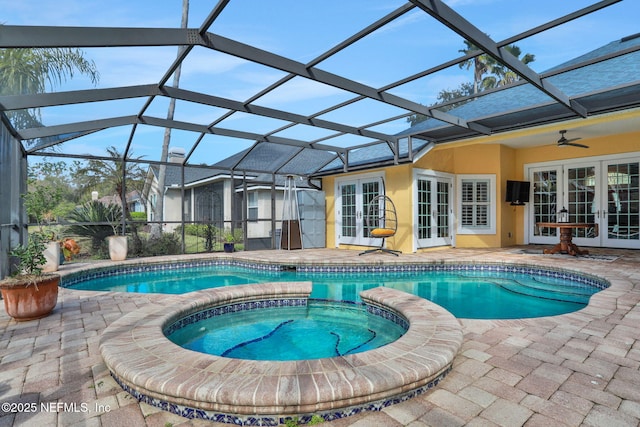 view of pool with french doors, a patio, glass enclosure, and a pool with connected hot tub