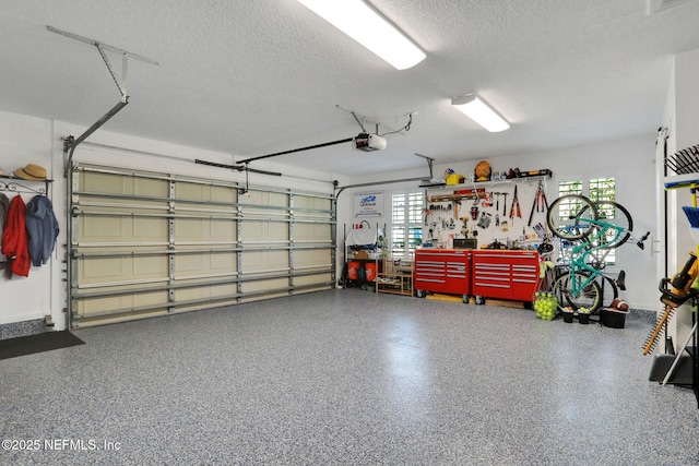 garage with a workshop area and a garage door opener