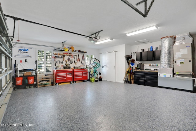 garage featuring a workshop area and a garage door opener