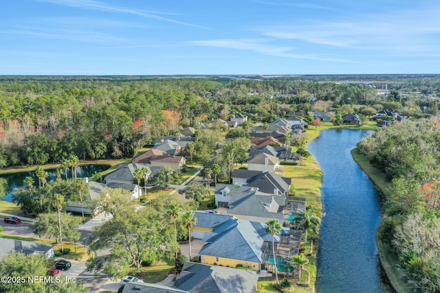 bird's eye view featuring a residential view, a water view, and a wooded view