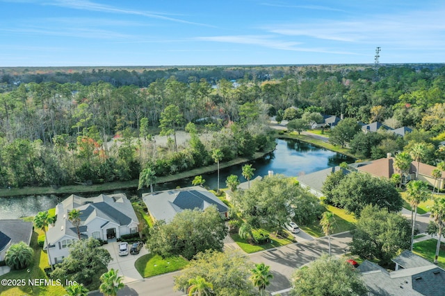 aerial view with a forest view, a water view, and a residential view