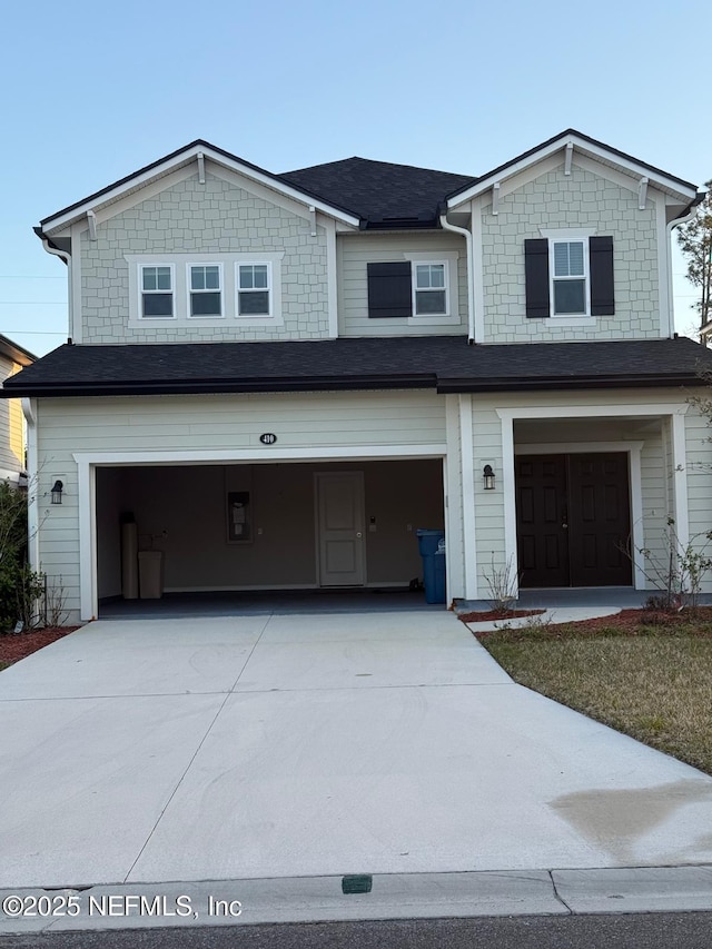 view of front of house featuring concrete driveway and a garage