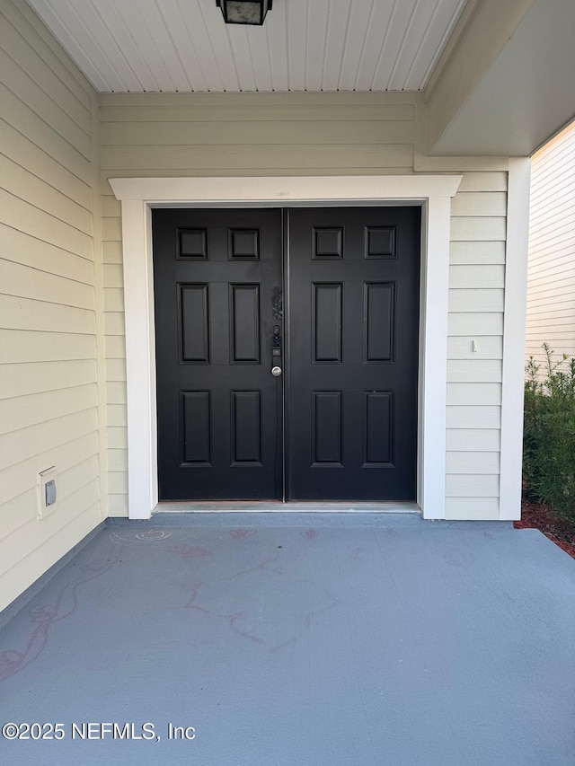 doorway to property with a garage