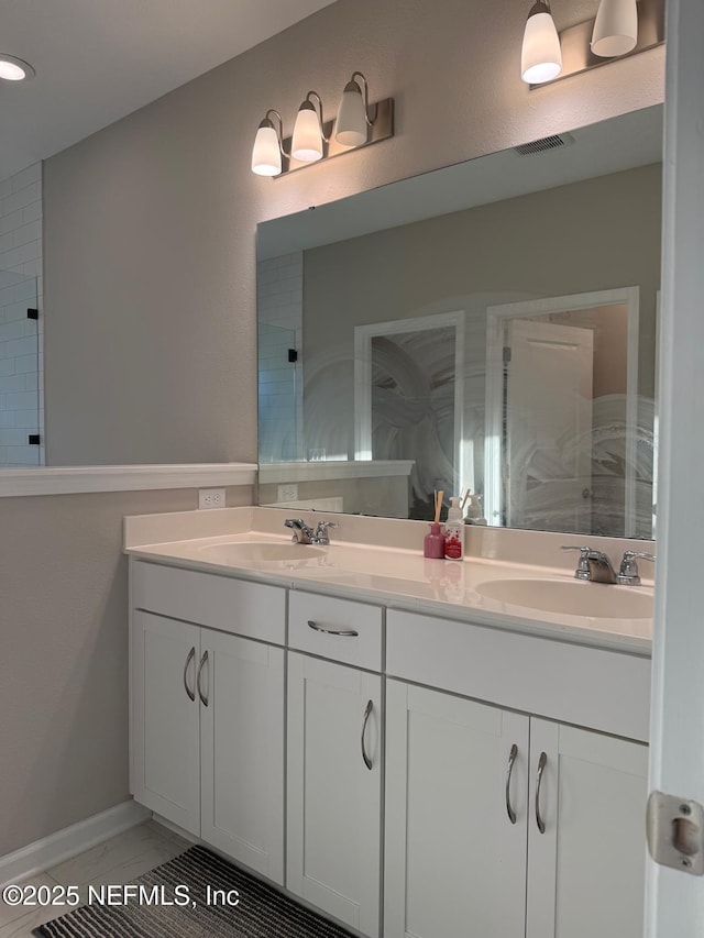 bathroom featuring a sink, visible vents, double vanity, and a tile shower