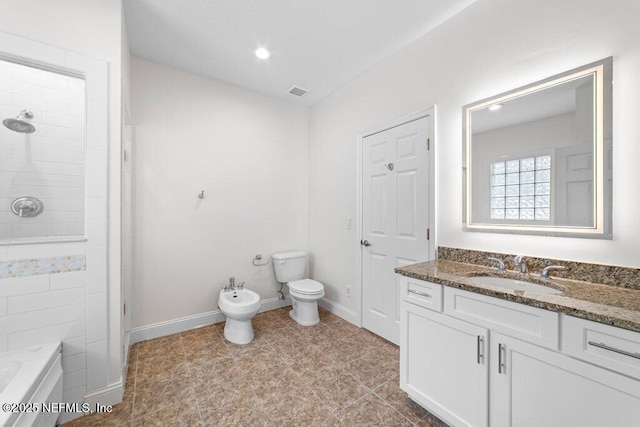 bathroom featuring baseboards, tiled shower, vanity, and a bidet