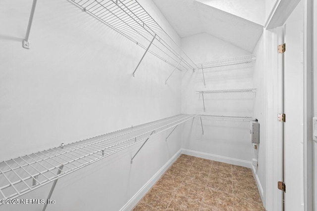 spacious closet featuring vaulted ceiling