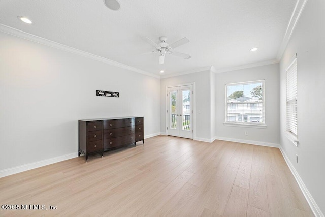 empty room with ceiling fan, baseboards, crown molding, and light wood-style floors