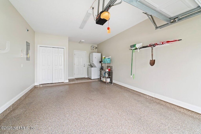 garage with electric panel, a garage door opener, and baseboards