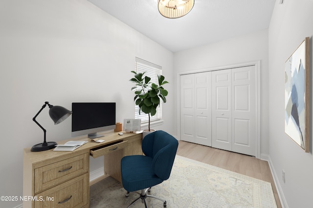 office area with light wood finished floors and baseboards