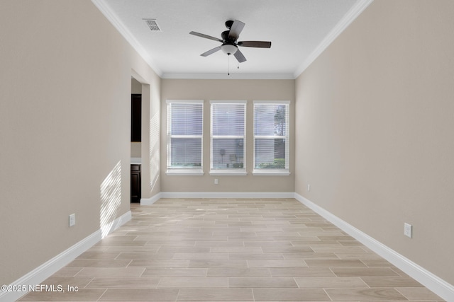 unfurnished living room featuring light wood finished floors, visible vents, baseboards, ornamental molding, and a ceiling fan