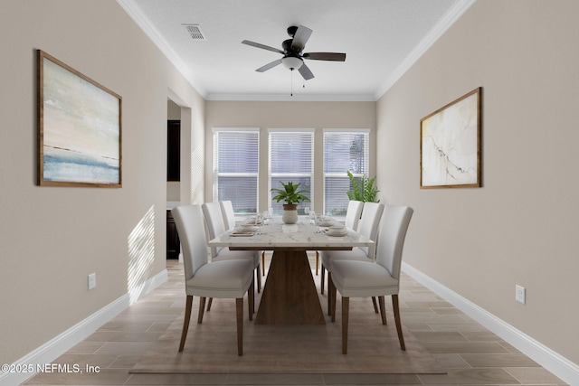 dining room featuring baseboards, visible vents, and ornamental molding