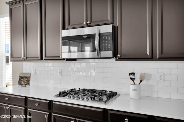 kitchen with light countertops, tasteful backsplash, and stainless steel appliances