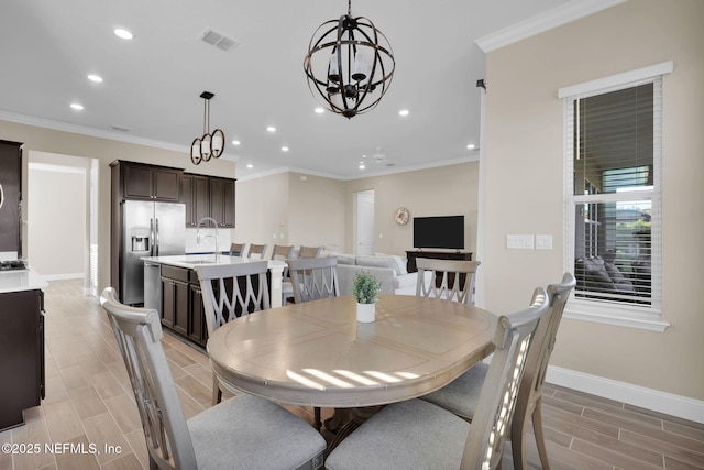 dining area with visible vents, baseboards, ornamental molding, and wood tiled floor