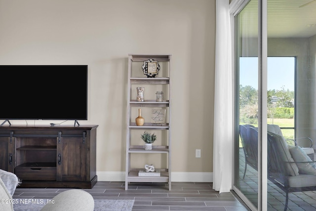 living room featuring baseboards and wood tiled floor