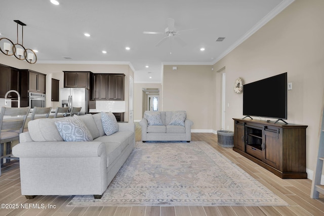 living room featuring ornamental molding, recessed lighting, baseboards, and wood finish floors