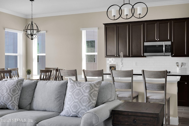 interior space featuring wood finished floors, a chandelier, and ornamental molding