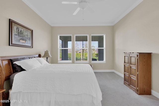 bedroom with carpet flooring, ceiling fan, crown molding, and baseboards