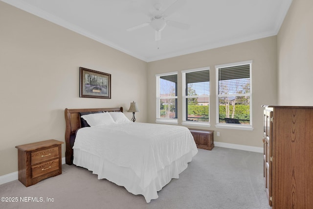 bedroom featuring light carpet, a ceiling fan, crown molding, and baseboards