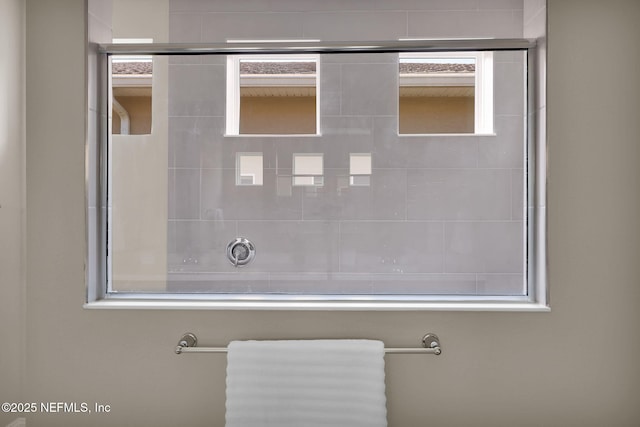 bathroom with a tile shower