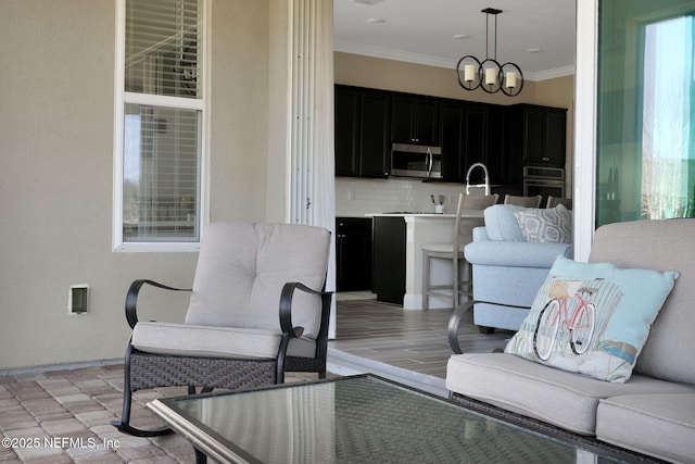 living room featuring a notable chandelier and ornamental molding